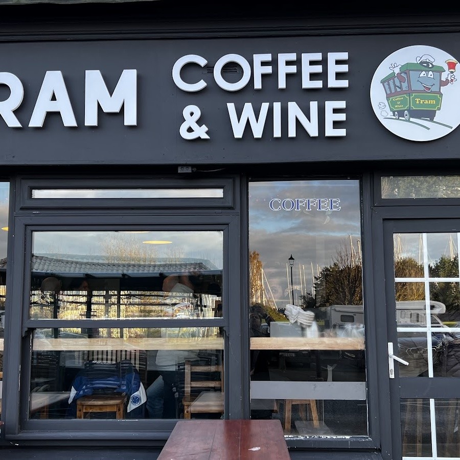 The tram mascot logo and lettering on the shopfront sign at Tram Coffee & Wine